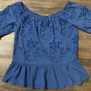 Navy blue blouse with floral sewing.